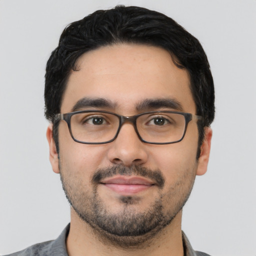 Joyful white young-adult male with short  black hair and brown eyes