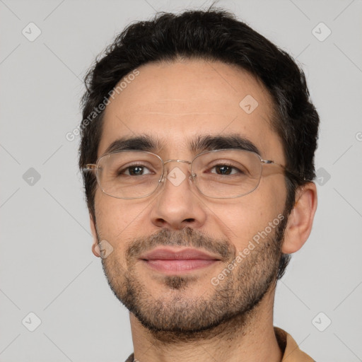 Joyful white adult male with short  black hair and brown eyes