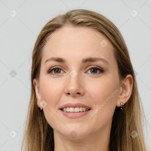 Joyful white young-adult female with long  brown hair and grey eyes