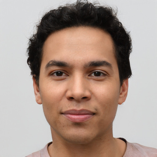 Joyful latino young-adult male with short  brown hair and brown eyes