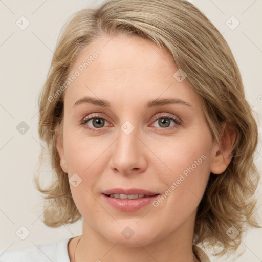 Joyful white young-adult female with medium  brown hair and blue eyes