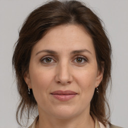 Joyful white adult female with medium  brown hair and brown eyes