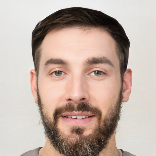 Joyful white young-adult male with short  black hair and brown eyes