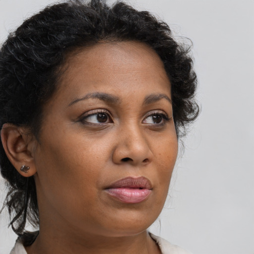 Neutral black adult female with long  brown hair and brown eyes