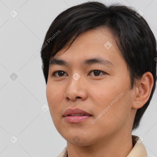 Joyful asian young-adult male with short  brown hair and brown eyes