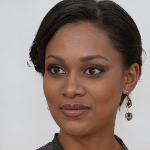 Joyful black young-adult female with medium  brown hair and brown eyes