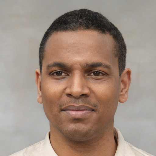 Joyful latino adult male with short  black hair and brown eyes