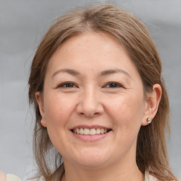 Joyful white adult female with medium  brown hair and brown eyes