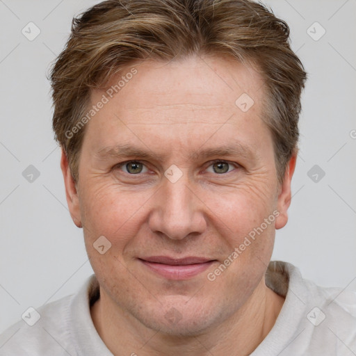 Joyful white adult male with short  brown hair and grey eyes