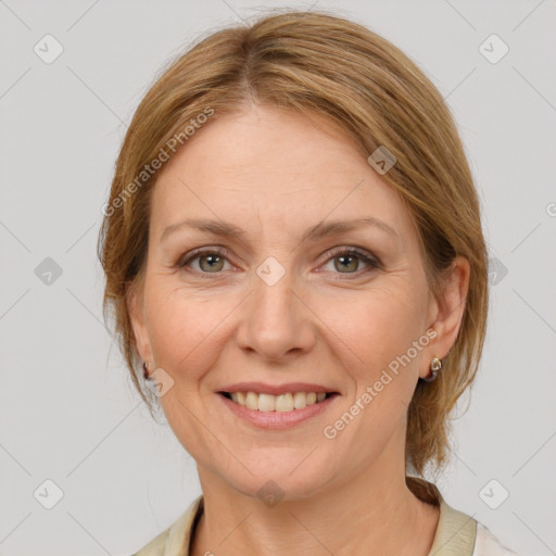 Joyful white adult female with medium  brown hair and grey eyes