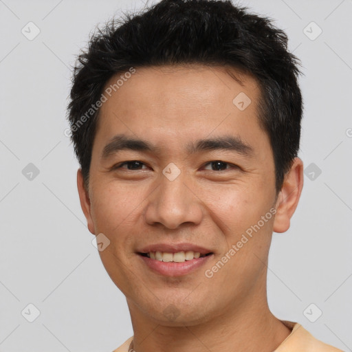 Joyful asian young-adult male with short  black hair and brown eyes