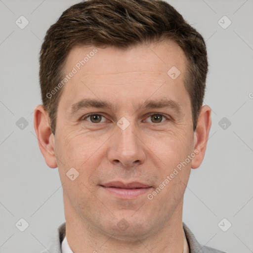 Joyful white adult male with short  brown hair and grey eyes