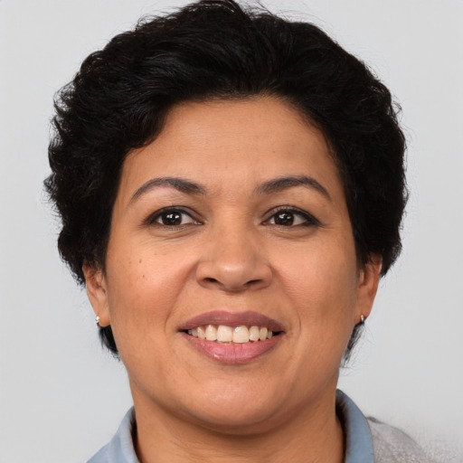 Joyful latino adult female with short  brown hair and brown eyes