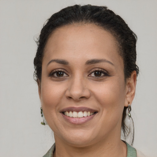 Joyful latino young-adult female with short  brown hair and brown eyes