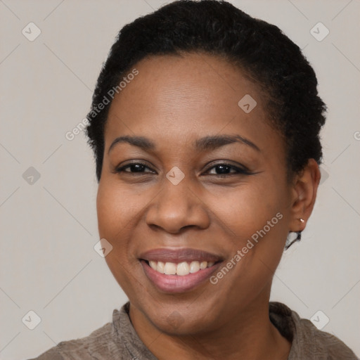 Joyful black adult female with short  black hair and brown eyes