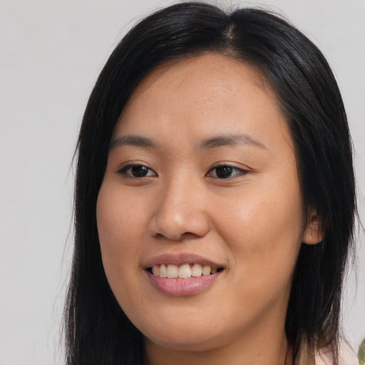 Joyful asian young-adult female with long  brown hair and brown eyes