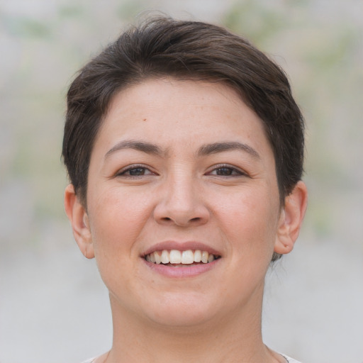 Joyful white young-adult female with short  brown hair and brown eyes
