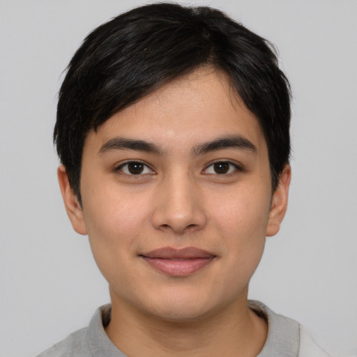 Joyful asian young-adult male with short  brown hair and brown eyes