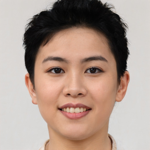 Joyful asian young-adult female with short  brown hair and brown eyes
