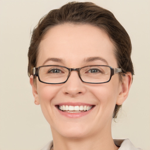 Joyful white adult female with short  brown hair and green eyes