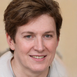 Joyful white adult female with short  brown hair and grey eyes