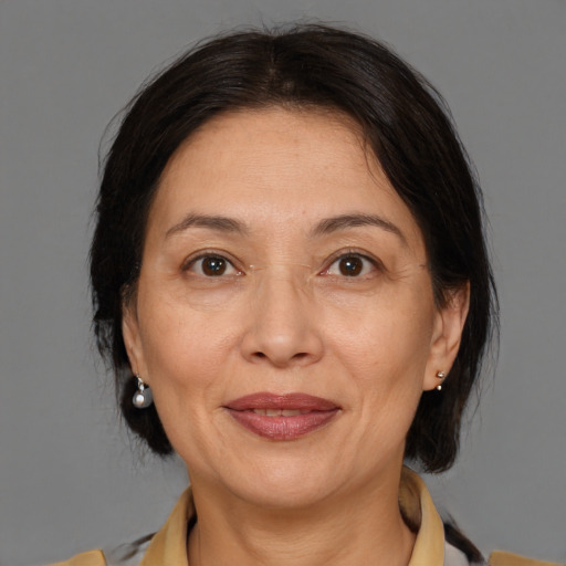 Joyful white adult female with medium  brown hair and brown eyes