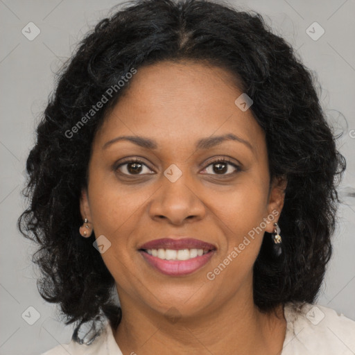 Joyful black young-adult female with long  brown hair and brown eyes