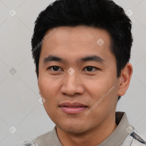 Joyful asian young-adult male with short  black hair and brown eyes