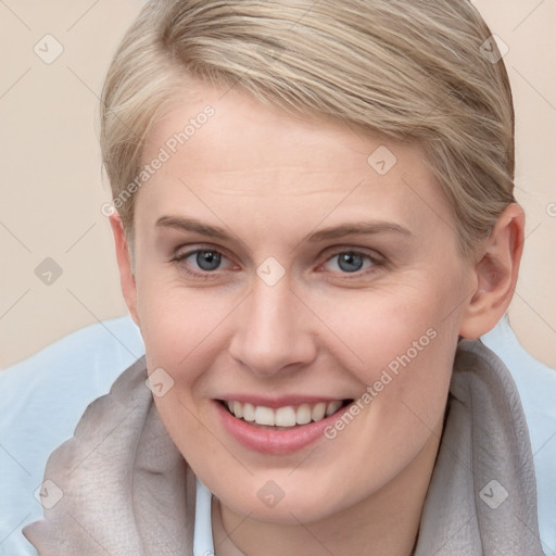 Joyful white young-adult female with short  brown hair and blue eyes