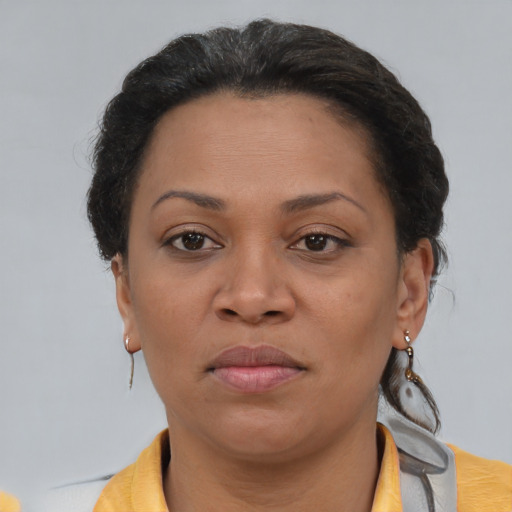 Joyful black adult female with short  brown hair and brown eyes