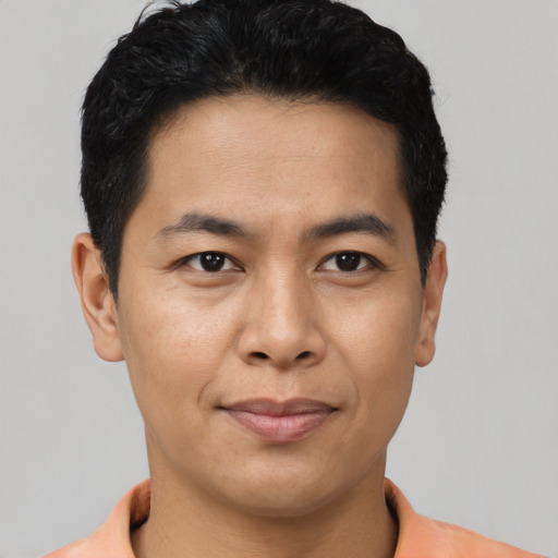 Joyful asian young-adult male with short  black hair and brown eyes
