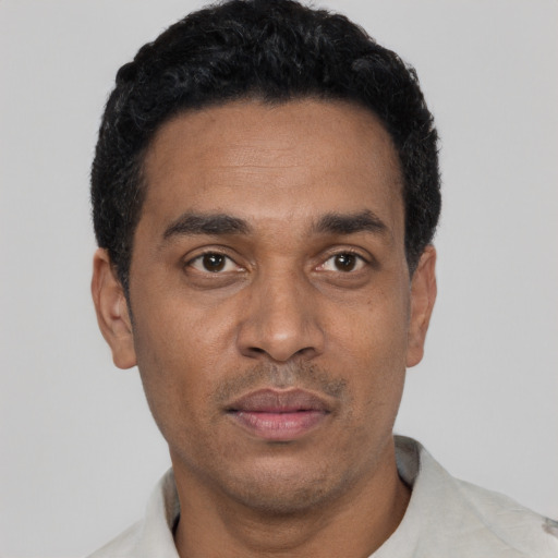 Neutral latino adult male with short  black hair and brown eyes