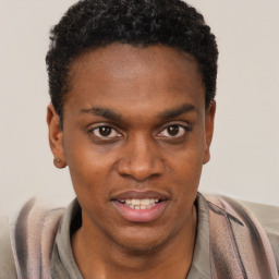 Joyful black young-adult male with short  brown hair and brown eyes