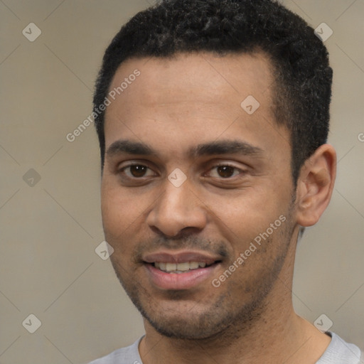 Joyful black young-adult male with short  black hair and brown eyes