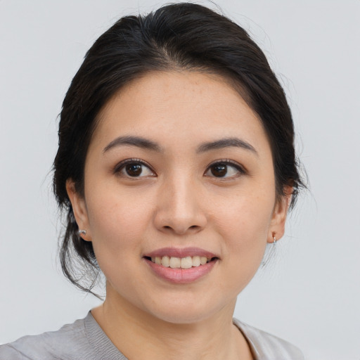 Joyful asian young-adult female with medium  black hair and brown eyes