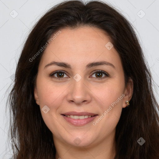 Joyful white adult female with long  brown hair and brown eyes