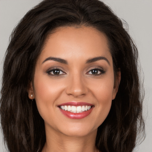 Joyful white young-adult female with long  brown hair and brown eyes