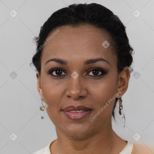 Joyful black adult female with short  black hair and brown eyes