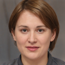 Joyful white adult female with medium  brown hair and brown eyes