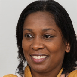 Joyful black young-adult female with medium  brown hair and brown eyes