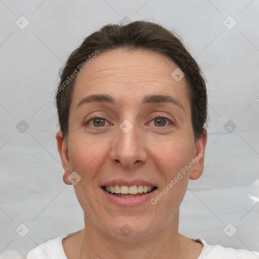 Joyful white adult female with short  brown hair and brown eyes