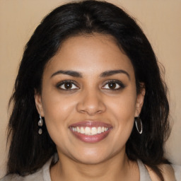 Joyful latino young-adult female with long  brown hair and brown eyes