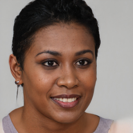Joyful black young-adult female with short  brown hair and brown eyes