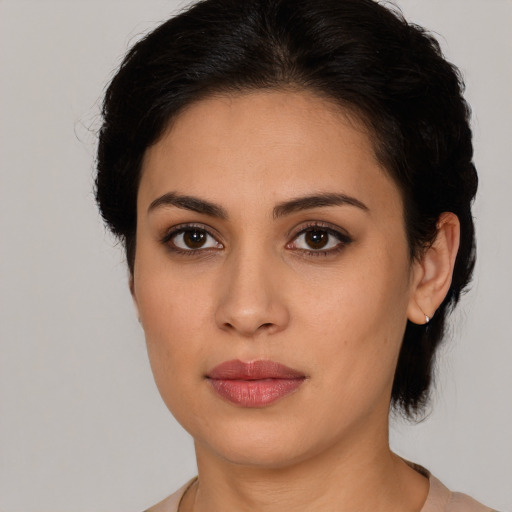 Joyful latino young-adult female with short  brown hair and brown eyes