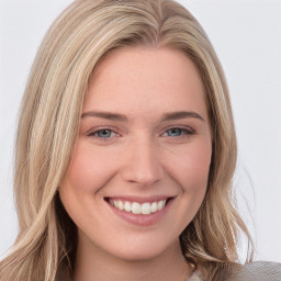 Joyful white young-adult female with long  brown hair and blue eyes