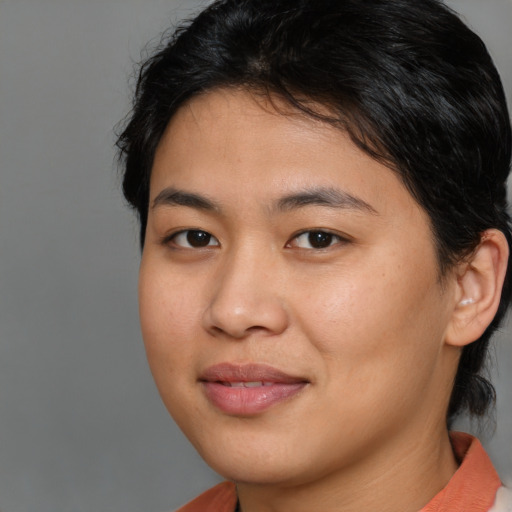 Joyful asian young-adult female with medium  brown hair and brown eyes