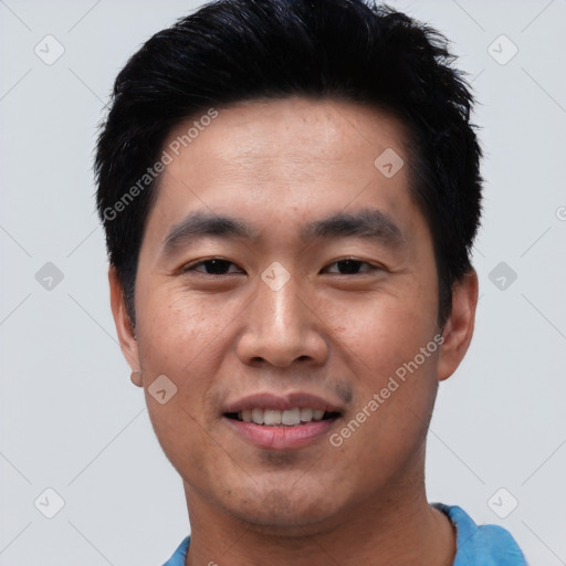 Joyful asian young-adult male with short  black hair and brown eyes