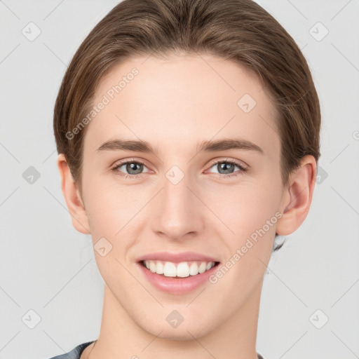 Joyful white young-adult female with medium  brown hair and grey eyes