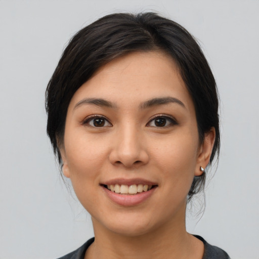 Joyful asian young-adult female with medium  black hair and brown eyes