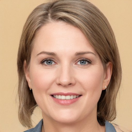 Joyful white adult female with medium  brown hair and grey eyes